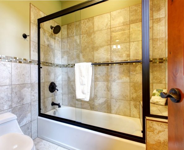 Top quality shower bath tub with stone tiles and toilet.